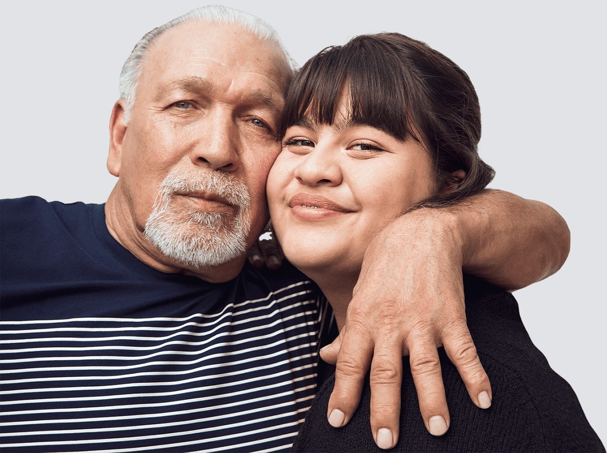 Father and daughter hugging. Actor portrayal.