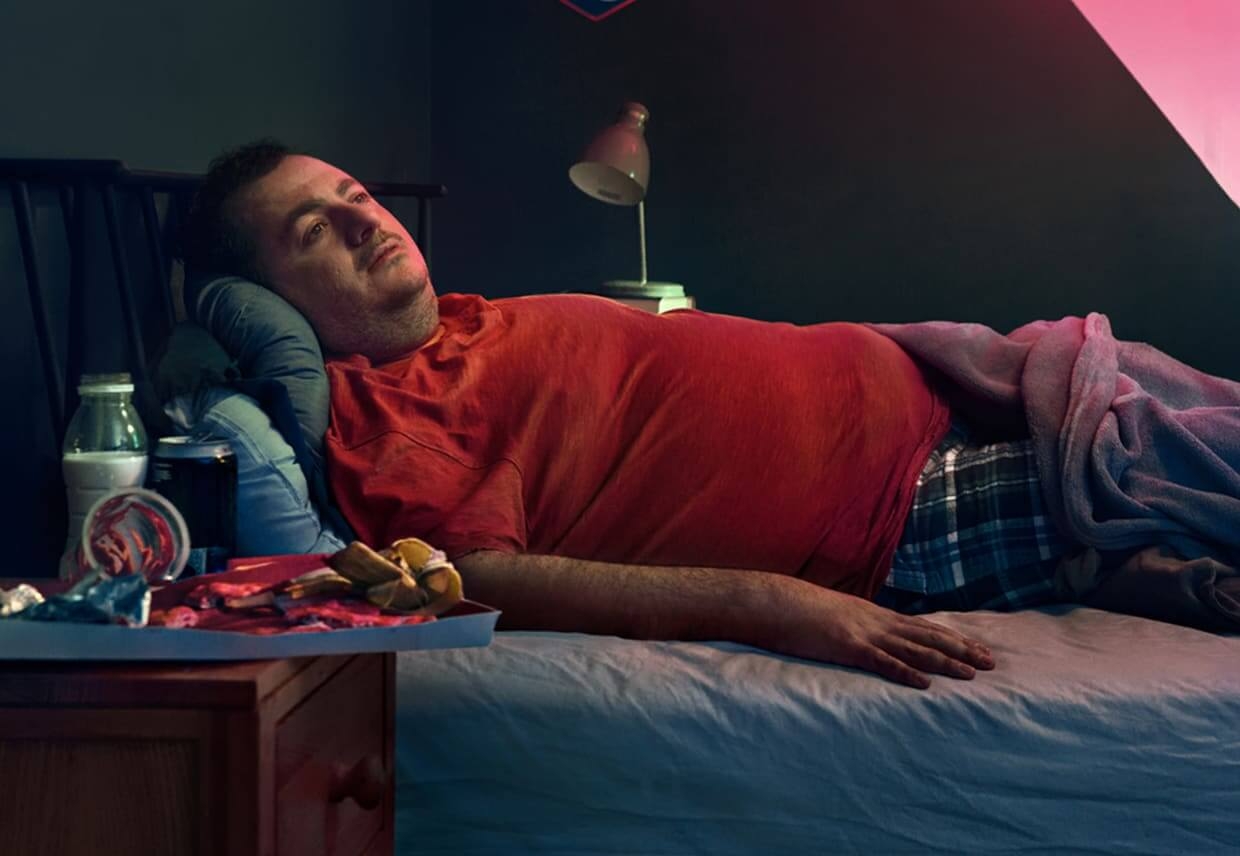 Man laying in a bed. Actor portrayal.